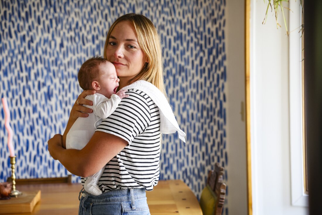 In August, Mary Collins and Rory's daughter were both recovering after Collins had high blood pressure during pregnancy, which led to Rory's premature delivery. Mary is a blonde-haired young woman standing in her dining room, holding her tiny, still-gestating baby.